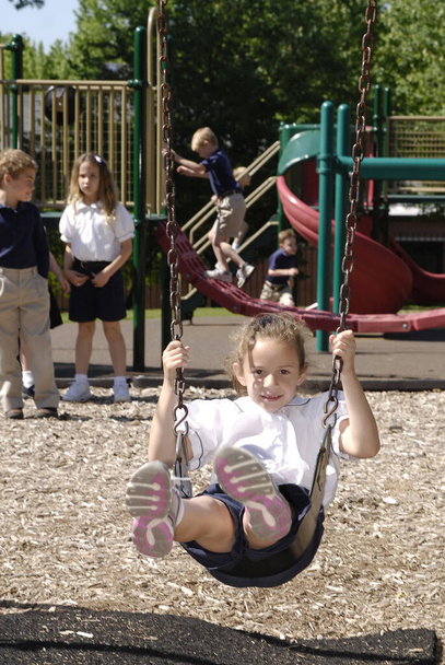 SAINT CHARLES, UNITED STATES - May 21, 2009: A catholic elementary schoolkid playing on the school playground with pupils in St. Charles, Missouri - Foto, immagini