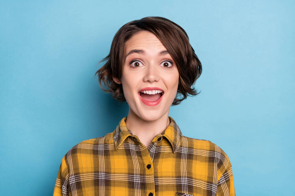 Photo of astonished girl open mouth omg sale reaction wear checkered shirt isolated blue color background - Valokuva, kuva
