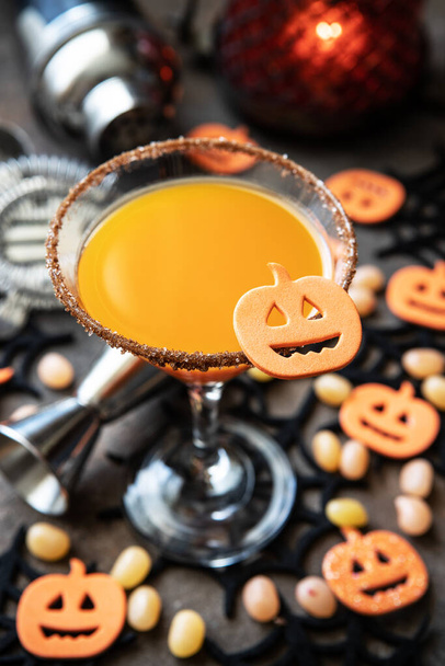 Halloween orange cocktail. Food Concept, glasses with  Spooky and holiday decorations on dark background - Foto, Imagem