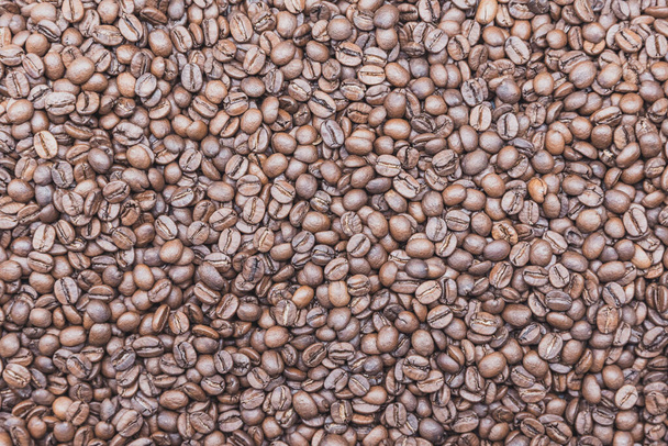 Background from brown coffee beans, top view - Foto, Imagen
