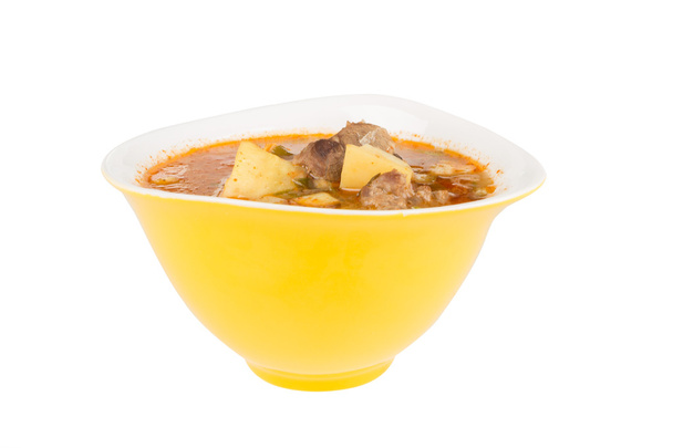 Sopa de goulash em uma tigela amarela
 - Foto, Imagem