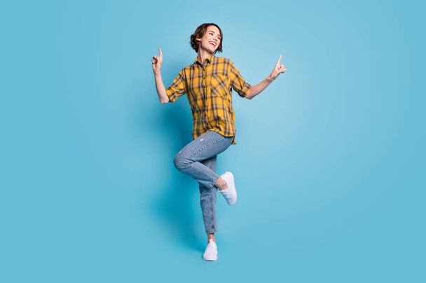 Photo of carefree cute lady dance enjoy discotheque wear checkered shirt jeans shoes isolated blue color background - Valokuva, kuva
