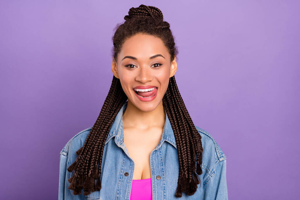 Photo of young attractive afro girl happy positive smile lick tongue teeth yummy isolated over violet color background - Foto, Imagen