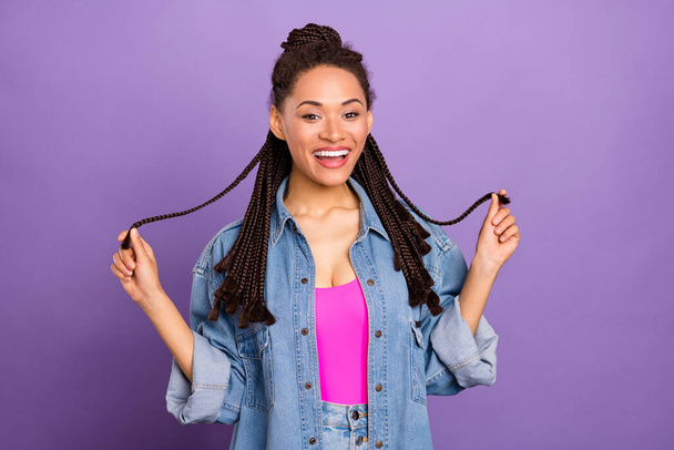 Portrait of attractive brunette cheerful girl playing with curls having fun isolated over bright purple violet red color background - Fotoğraf, Görsel