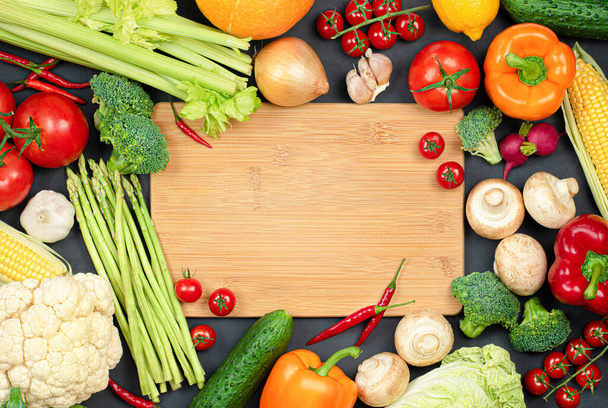 cutting board and many different vegetables for cooking - Photo, Image