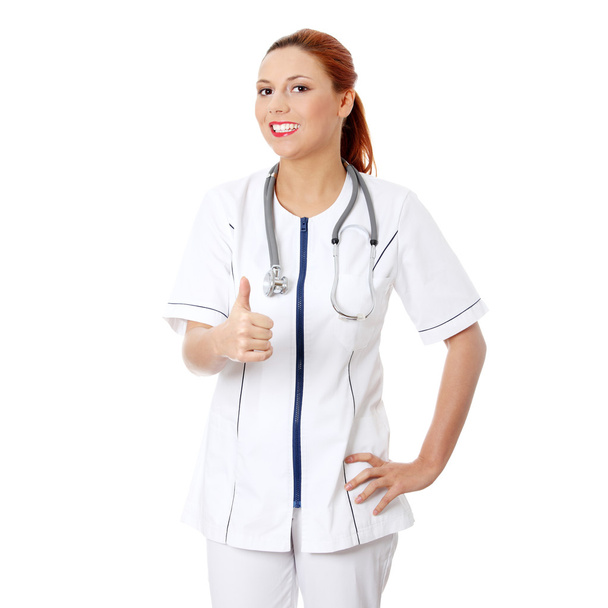 Female doctor or nurse gesturing ok, isolated on white - Foto, Imagem