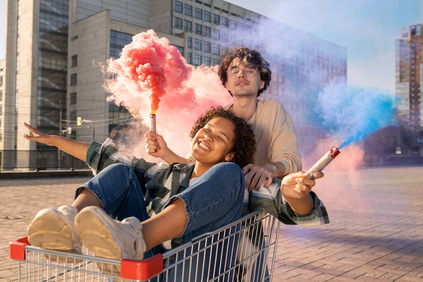 Contemporary teens with firecrackers having fun outside - Photo, Image