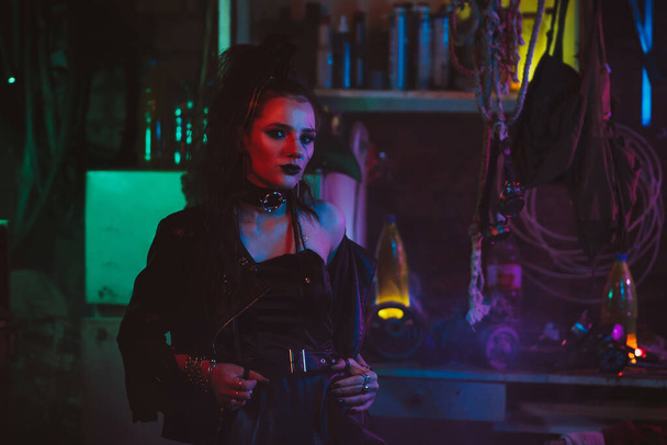 Portrait of a girl in the cyberpunk style with hair and makeup with a neon light - Photo, Image