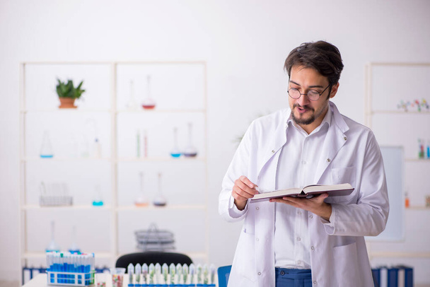 Young male chemist in drugs synthesis concept - Photo, Image