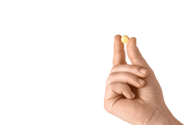 Female hand and pill on white background - Foto, Imagen
