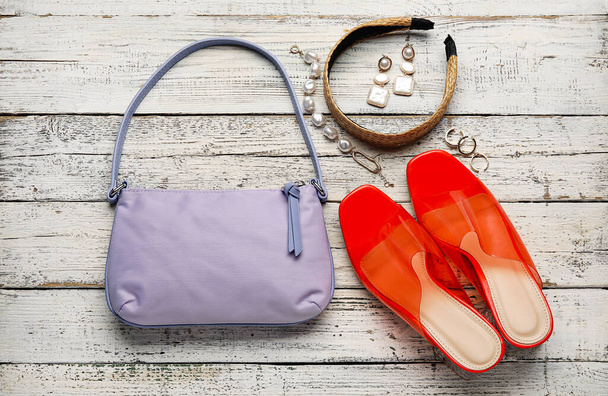 Trendy handbag, shoes and different accessories on wooden background - Photo, Image