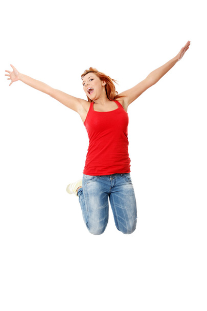 Young happy caucasian woman jumping in the air - Φωτογραφία, εικόνα