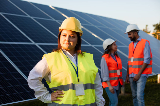 Overweight woman engineer posing at the solar station - Foto, Bild