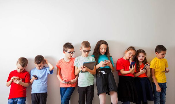 Schoolchildren with gadgets watching online live broadcasting - Foto, Imagen