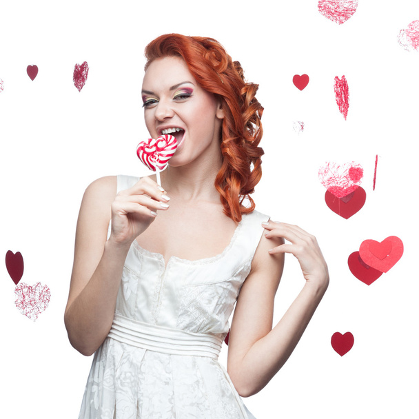 surprised red-haired woman holding lollipop - Fotografie, Obrázek