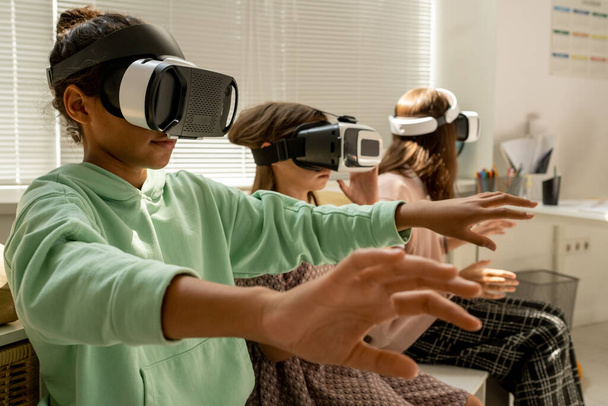 Contemporary schoolgirl and her two classmates in vr headsets - Photo, Image