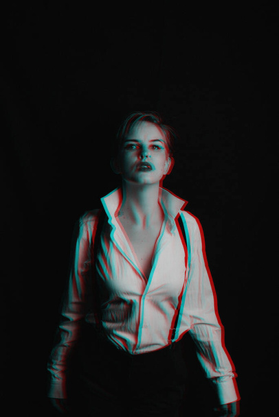portrait of a girl in a white shirt with suspenders and red lipstick. photo with the thrown grain. Black and white with 3D glitch virtual reality effect - Foto, immagini