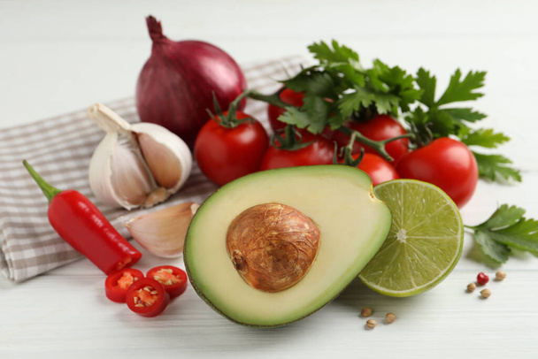 Fresh ingredients for guacamole on white wooden table - Photo, Image