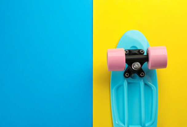 Turquoise skateboard on color background, top view. Space for text - Photo, Image