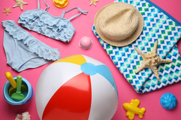 Beach ball and sand toys on pink background - 写真・画像