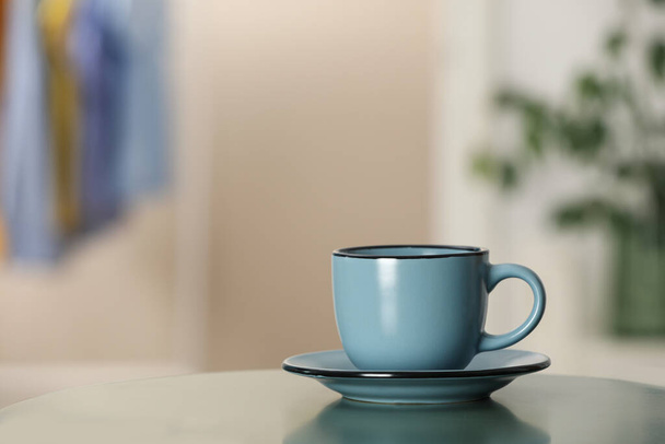 Ceramic cup on table in room, space for text - Foto, Imagem