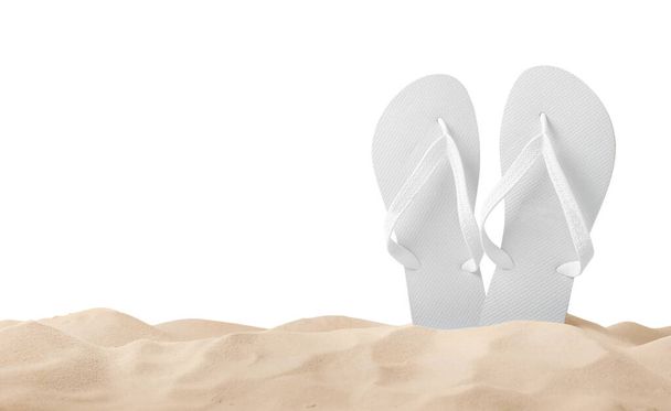 Bright flip flops in sand on white background - Valokuva, kuva