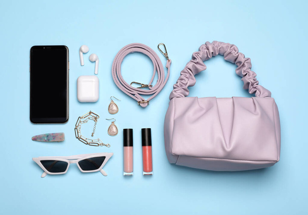 Flat lay composition with stylish woman's bag on turquoise background - Photo, Image