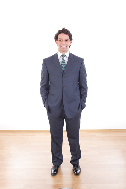  smiling businessman in black suit casual poses at studio - Foto, Bild