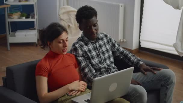 Young interracial couple talking on video call conference - Footage, Video