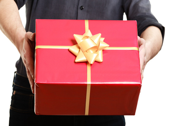 Man giving red gift box with golden ribbon - Fotó, kép