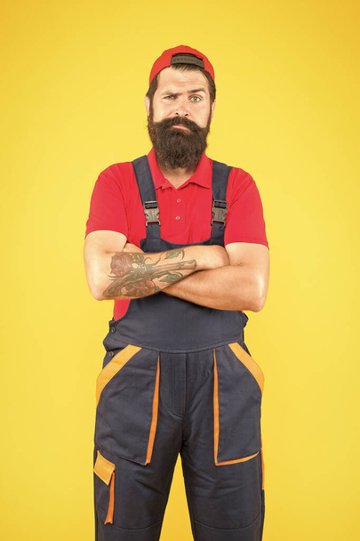 mature man worker with beard wear uniform, repair - Foto, afbeelding