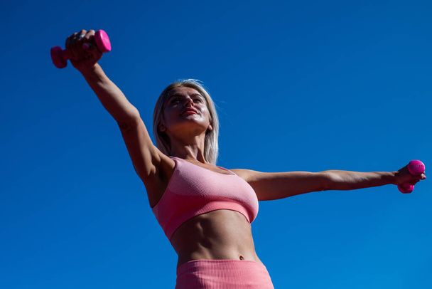 athletic woman in fitness wear hold barbells on stadium, biceps - Φωτογραφία, εικόνα