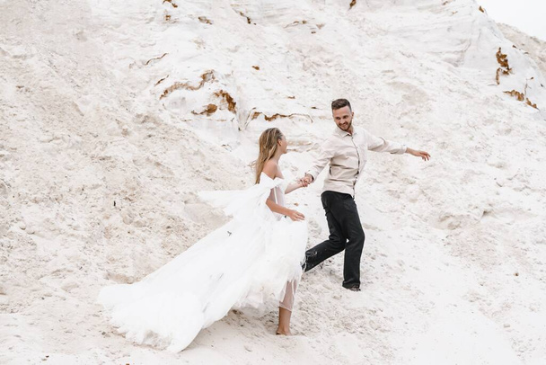 Beautiful wedding couple bride and groom wedding day outdoors beach. Happy marriage couple on nature,sunny lights.Loving man woman marriage day.white sand vacation travel honeymoon tenderness passion  - Photo, Image