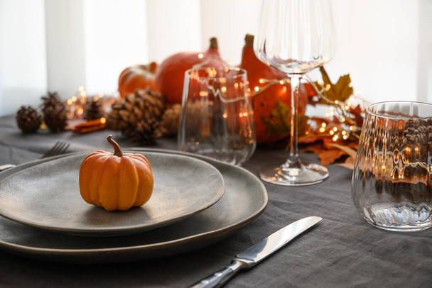 Halloween and Thanksgiving day dinner decorated fallen leaves, pumpkins, spices, grey plate. - Foto, imagen