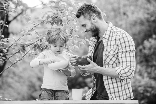 healthy food and dieting. Dairy products. childhood happiness. Baby food. son and father eating milk porridge. happy fathers day. Little boy with dad have breakfast. Happy family. Healthy snacks - Fotoğraf, Görsel