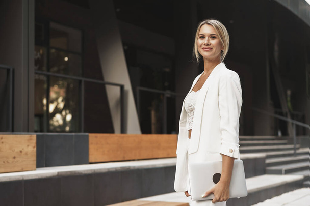 Portrait of beautiful smiling female in stylish office clothes in city - Foto, Imagen