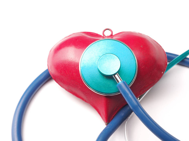 Stethoscope with a red heart shape on a white table, health care - 写真・画像
