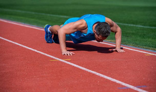 sport success. male athlete do morning exercise. pushups workout. sportsman planking outdoor. - Foto, afbeelding