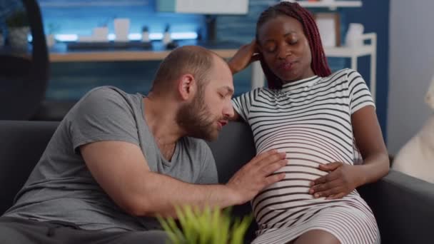Married interracial couple expecting child bonding at home - Footage, Video