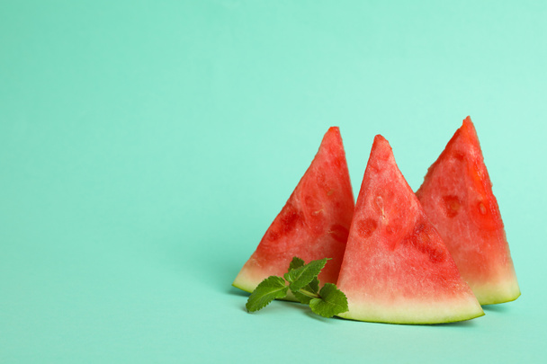 Watermelon slices and mint on mint background - Fotografie, Obrázek