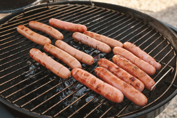 Juicy Delicious Hot Dogs on Grill - Фото, изображение