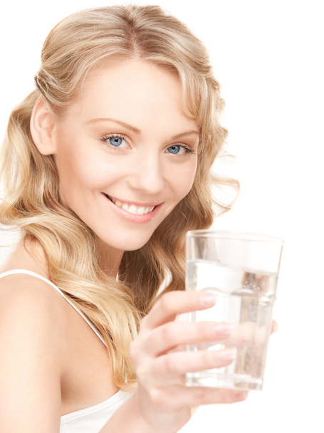 Beautiful woman with glass of water over white - 写真・画像