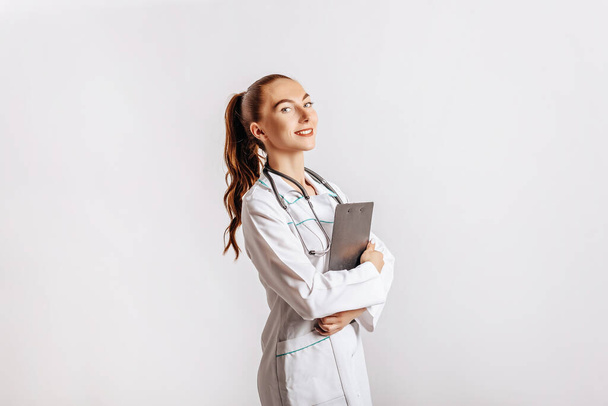 Medical documents. Doctor with stethoscope at hospital. Girl with folder. Nurse hold patient medical chart. Information data. Therapist in uniform. Medical history prescription. Woman work at clinic. - Fotó, kép