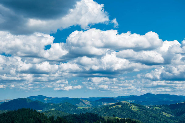 beautiful cloudy blue sky over green summer mountains, morning landscape - Photo, Image