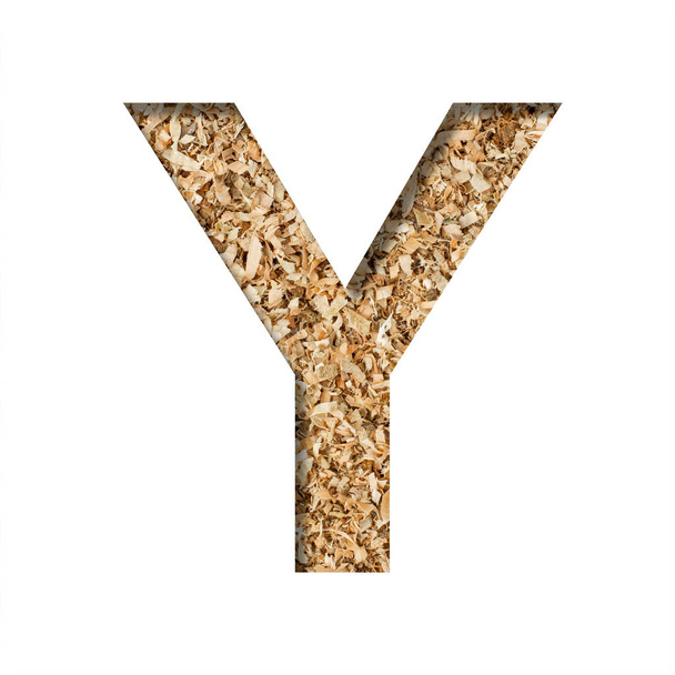 Sawdust wood font. The letter Y cut out of paper on the background of sawdust or small shavings of a fruit tree. Decorative alphabet for handmade or small production, font collection. - Φωτογραφία, εικόνα