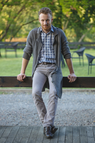 Portrait of handsome young man smiling outdoors - Foto, Imagem