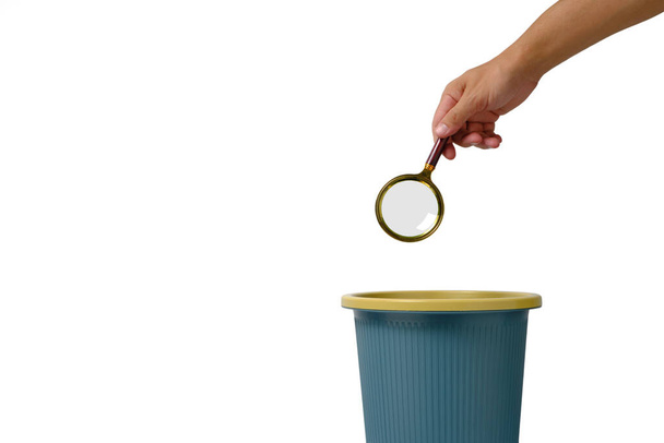 Magnifying glass is thrown into trash.Concept of meaningless search - Photo, image