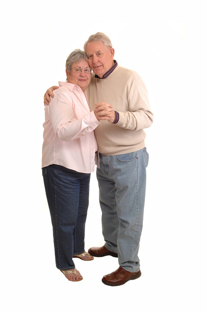 A couple of seniors in the sixties dancing in the studio, for white background. - Foto, Imagen
