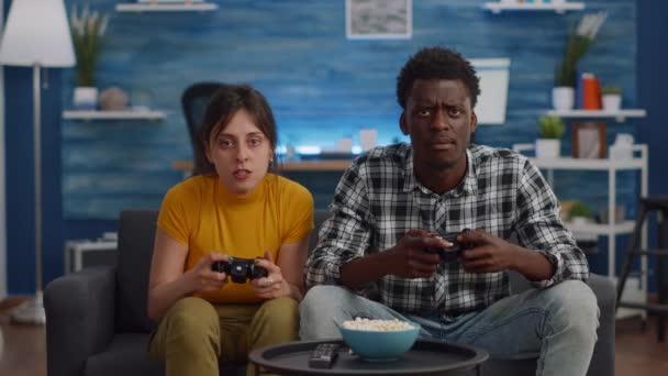 Modern interracial couple losing video game on TV - Footage, Video