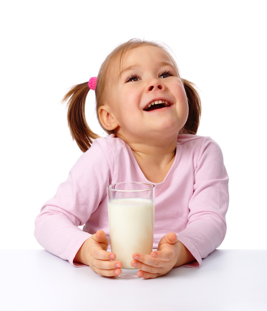 Cute little girl with a glass of milk, isolated over white - Photo, image